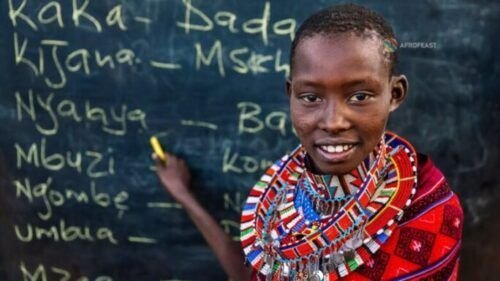 A young student in Kenya wearing traditional beadwork