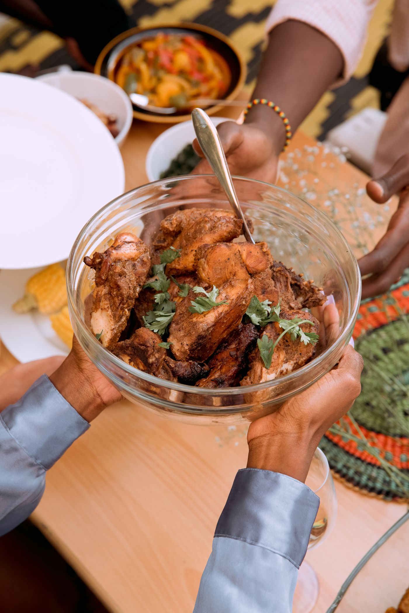 A bowl of richly browned roasted chicken garnished with fresh herbs